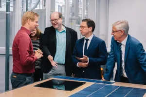 5 Personen stehen an einem Tisch mit Infomaterial