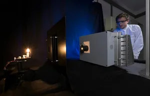 An employee calibrates a reference lamp