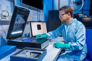 Researcher analyzing solar cells using a high-resolution measurement system.

