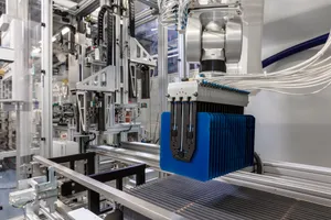 Automated manufacturing equipment for solar cell production with robotic gripper module.