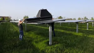 two persons testing a device to detect damage on a photovoltaic module